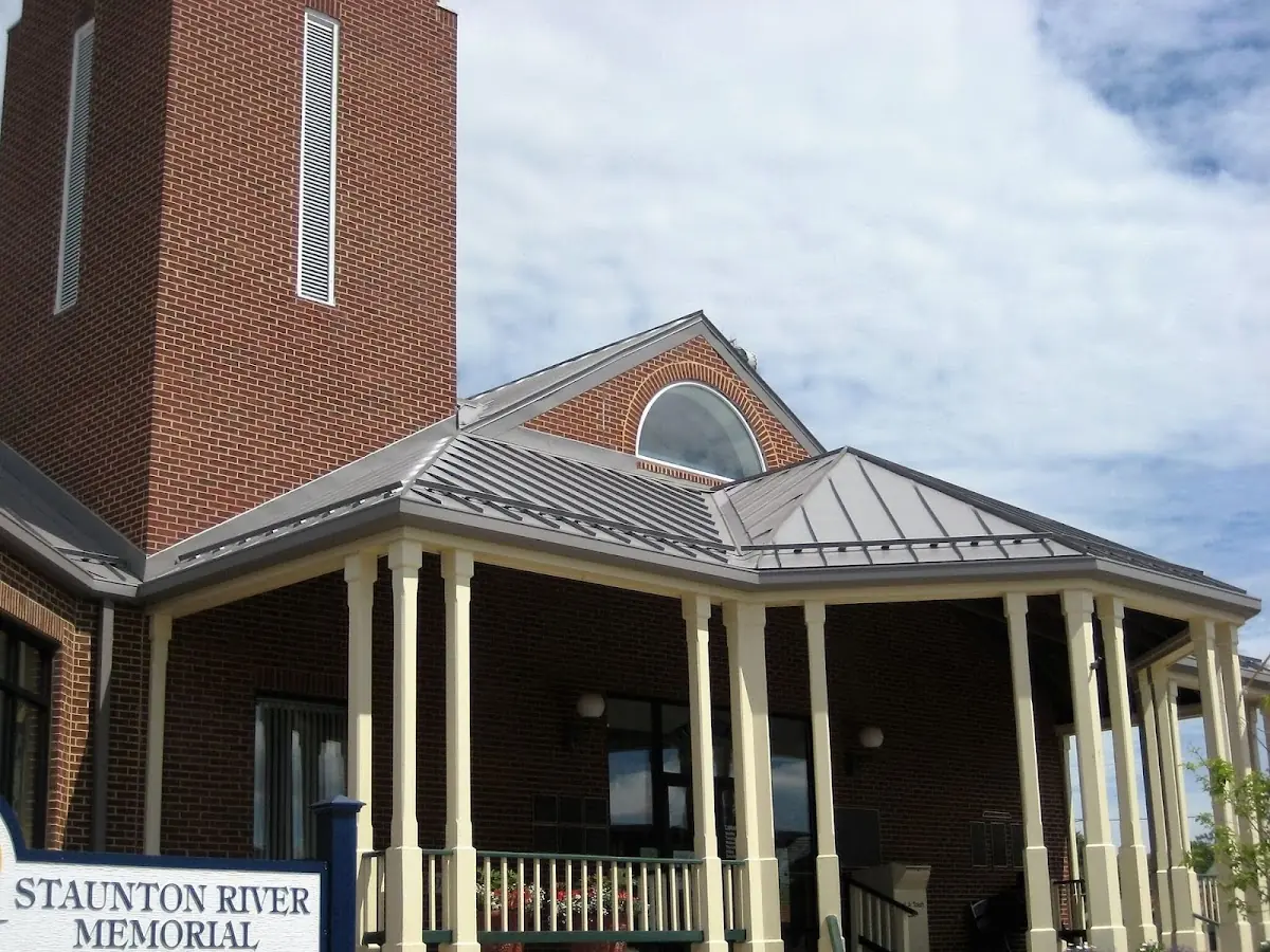 Skilled roofing craftsmen working on a residential roof in College Hill